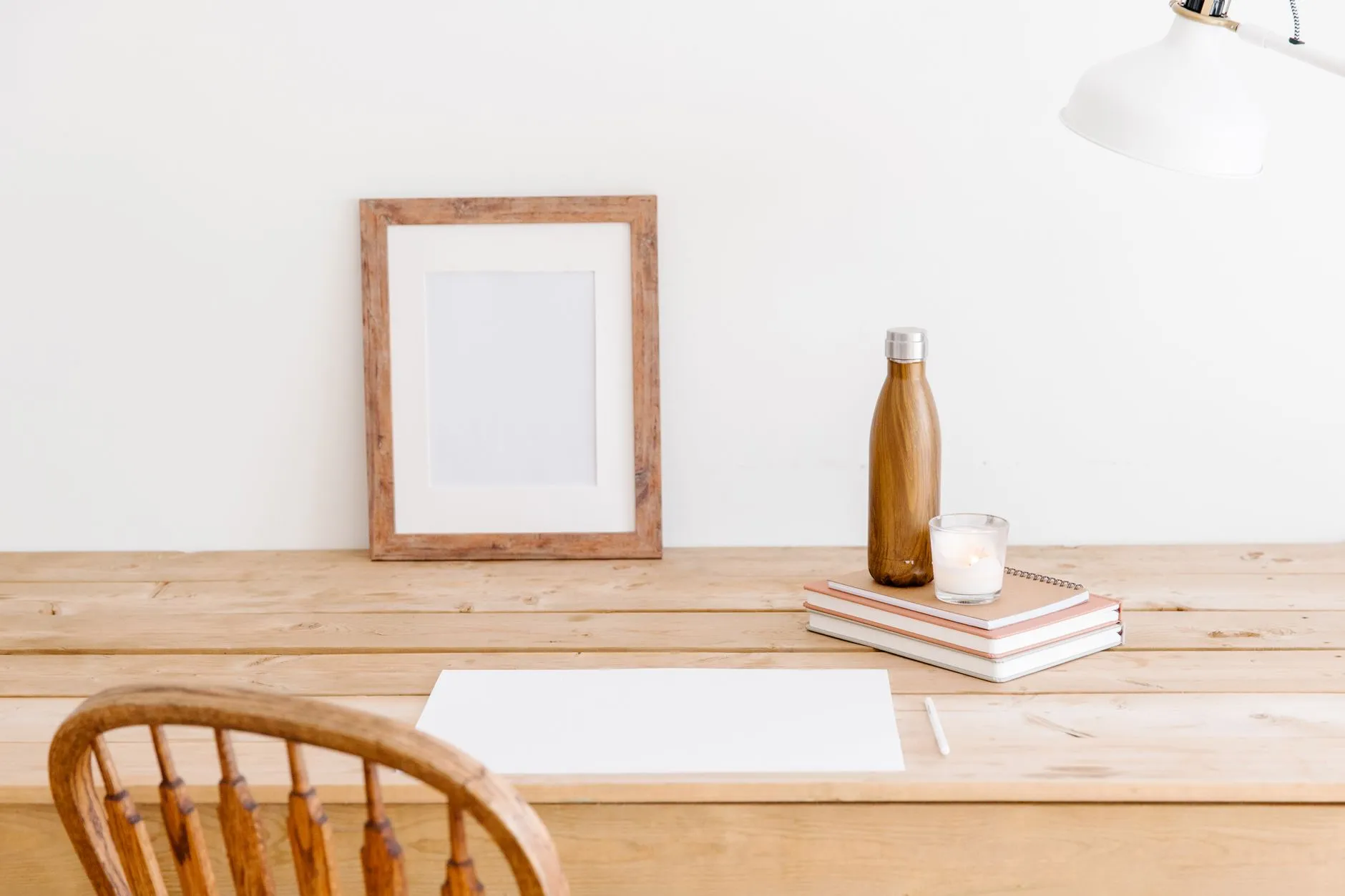 A bare desk and chair in a quiet corner of the studio
