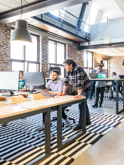Team of people working together in front of a laptop